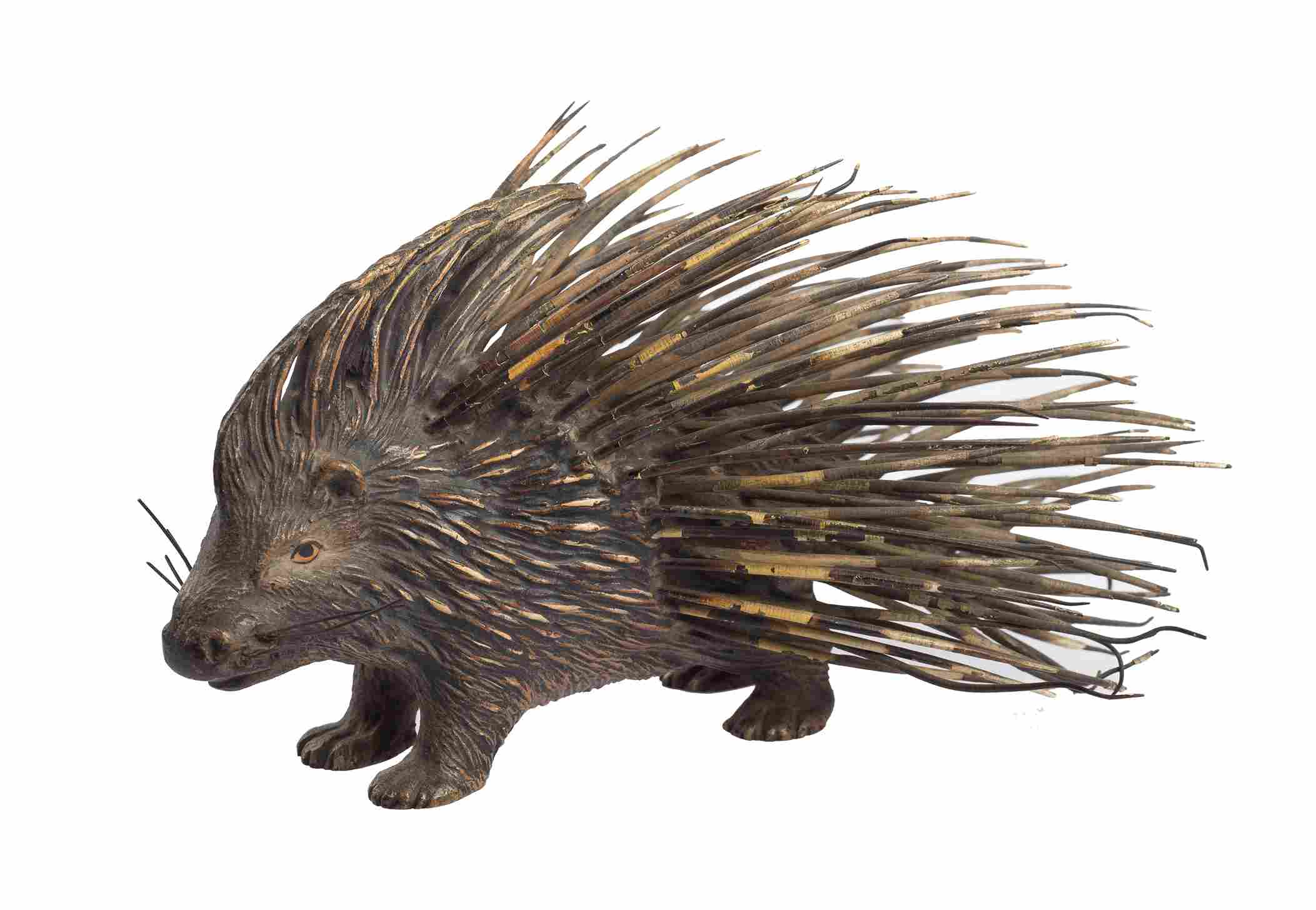 A small sculpture of a porcupine, made of what looks to be bronze.